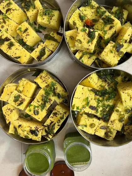 Khaman Dhoklas packed in steel containers to keep them fresh and soft, with chutney on the side.