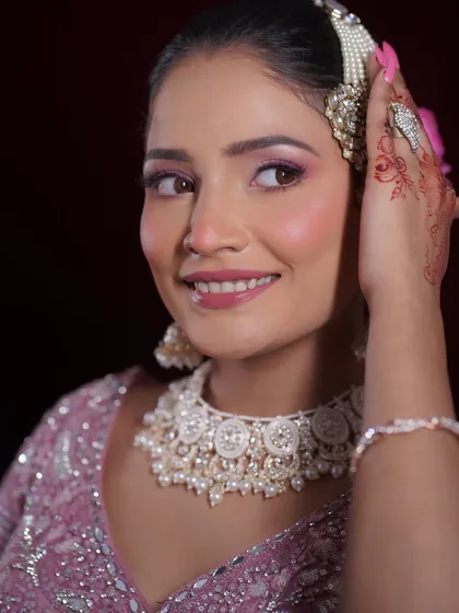 A happy, smiling shot of the bride. The makeup enhances her joy, with a focus on luminous skin and bright eyes.