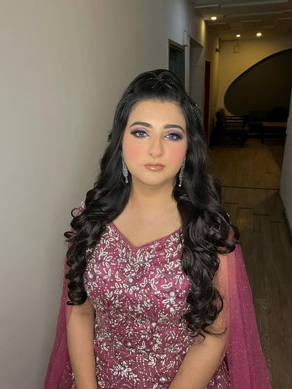 We love adding a bit of sparkle to our braids. This half-up style features a glittery braid that catches the light beautifully, perfect for a party.