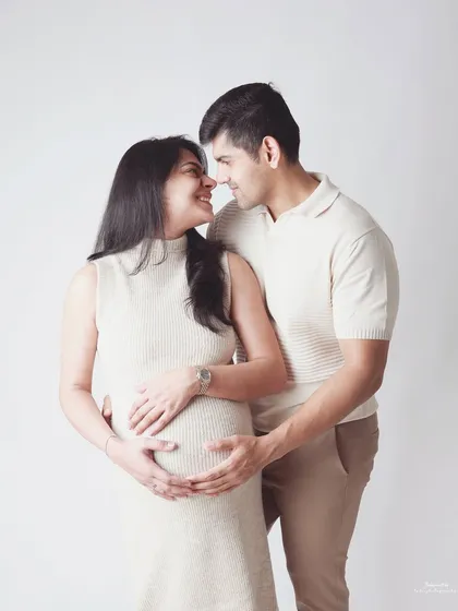 This is the kind of moment I love to capture. A simple, minimalist studio shot where the connection between you and your partner is the entire story. The soft smiles and gentle touch on the baby bump say everything.