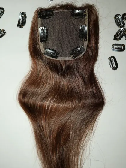 My clip-in hair toppers are a simple and effective solution for adding volume and coverage to the crown area. This piece shows the secure clips and the breathable base, designed for all-day comfort and a natural look.