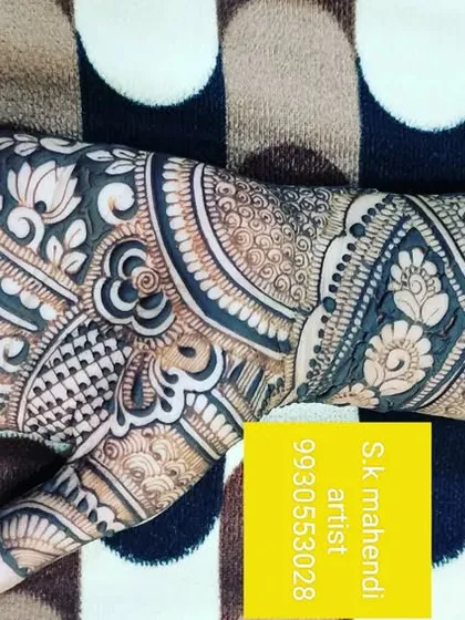 A detailed design for the back of the hand, featuring a peacock and intricate fill patterns. This style provides a rich look without covering the entire arm.