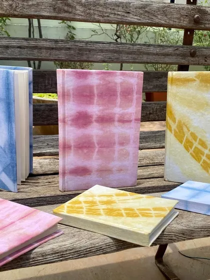 My collection of handmade notebooks, covered with fabric that I naturally dyed myself. They are available with ruled or unruled paper and are perfect for journaling, sketching, or gifting.