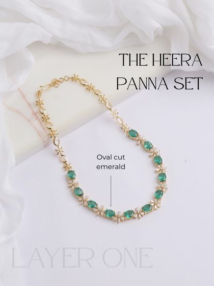 This image showcases the first, most delicate layer of the Heera Panna set. It's a beautiful chain of oval-cut emeralds and diamond floral motifs, perfect for everyday elegance.