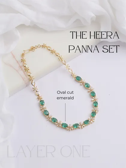 This image showcases the first, most delicate layer of the Heera Panna set. It's a beautiful chain of oval-cut emeralds and diamond floral motifs, perfect for everyday elegance.