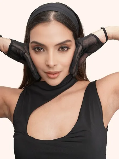 A confident and direct look to the camera, showcasing the clean and impactful makeup.