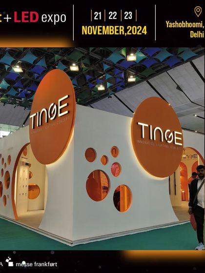 The Tinge booth makes a statement with its unique, circular-themed architecture and bold orange branding.