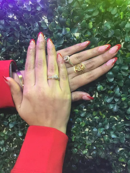 A full view of the red glitter French tip extensions. This look is bold, festive, and perfect for anyone who loves a bit of sparkle with a classic design.
