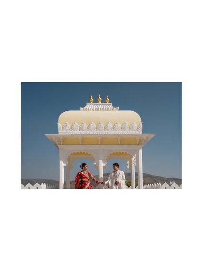 A wide shot capturing the architectural beauty of the wedding venue in Udaipur. We believe in setting the scene and showing the grandeur of the location as a part of the couple's story.
