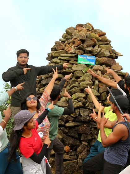 A fun group photo at the peak. The sense of achievement and camaraderie is high after completing the Kumaraparvatha trek.