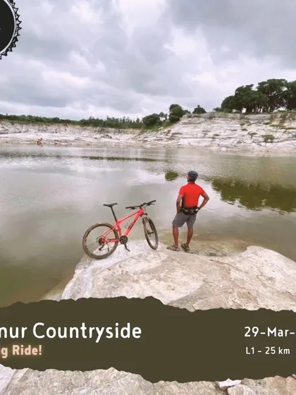 A rider and his bike at the edge of a quarry lake on our 'Hennur Countryside' evening ride. We find the most unique and scenic spots for our tours.