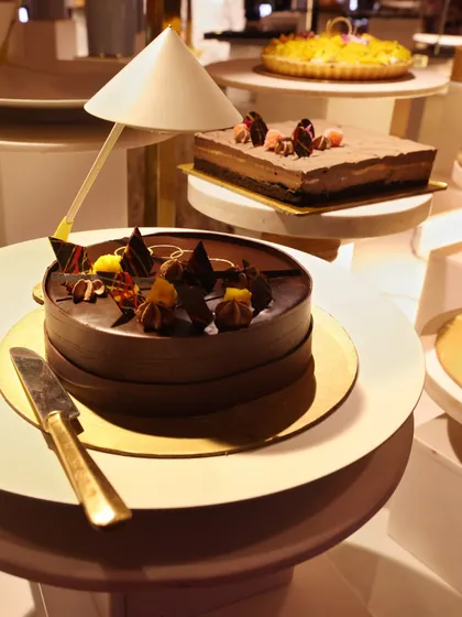 A selection of our finest cakes and pastries, including a beautifully decorated chocolate cake and a classic cheesecake.