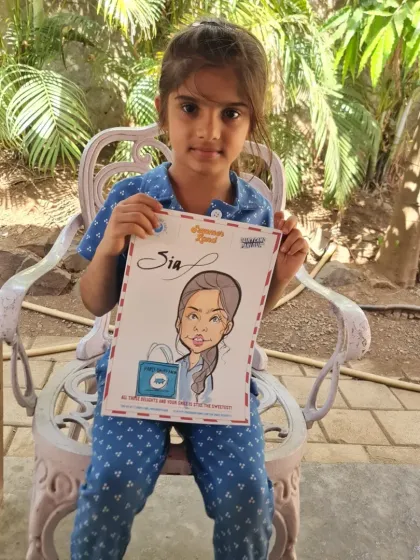 A young girl proudly holding up her personalized caricature. These make wonderful and unique gifts for children.