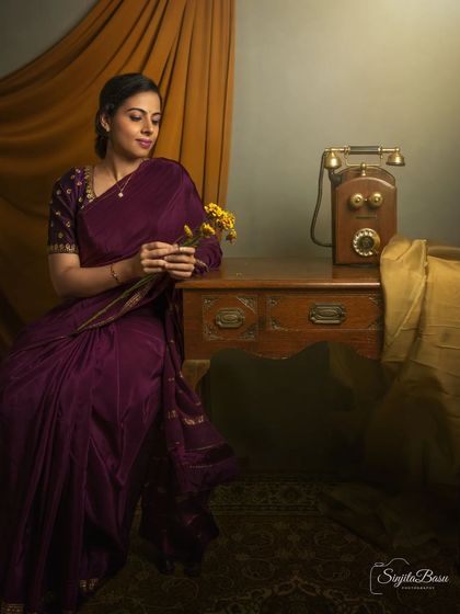 A duplicate of image 77, this portrait is a beautiful exercise in storytelling through props and mood. The antique telephone and thoughtful pose create a powerful sense of nostalgia and longing.