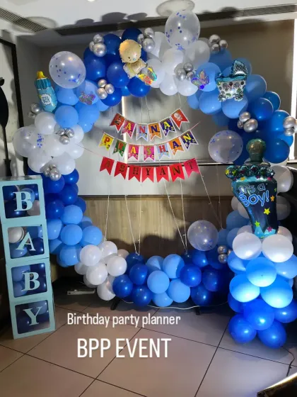 A full view of the Annaprashan ring backdrop, with 'It's a Boy' and baby bottle foil balloons.