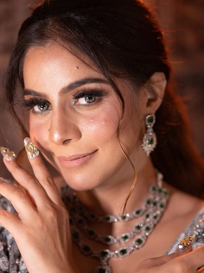 A close-up showing the detailed nail art and ring that add another layer of glamour to this party-ready ensemble.