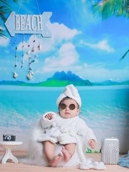 Our full beach set, complete with a vibrant ocean view, palm trees, and beach signs. We bring the vacation vibes right into our studio.