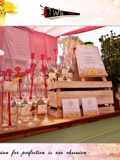 A beautiful display of glassware with custom stirrers and tags for a festive Mehendi party.