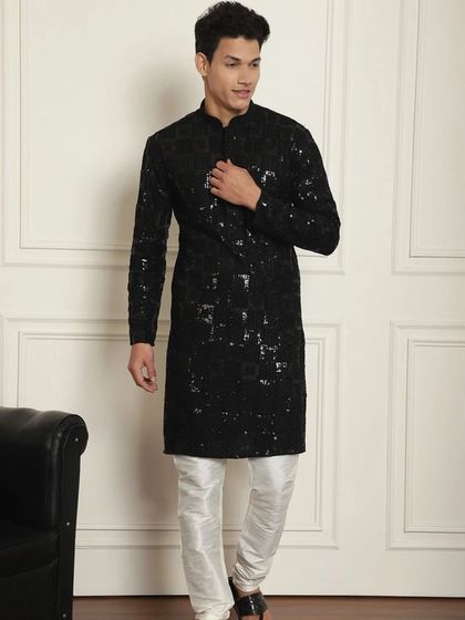 Ready to dazzle this Diwali. This black sequined kurta, paired with white pajamas, is crafted to make every moment unforgettable.