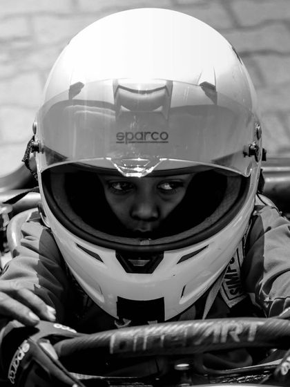 A powerful black and white close up of a young micro-max driver, showing that age is just a number when it comes to determination.
