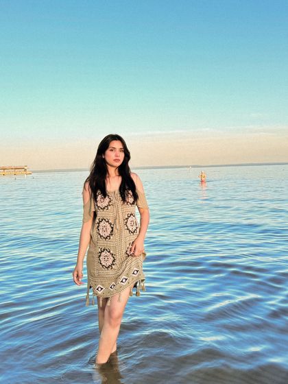 A confident pose in the water, looking like a still from a travel film.