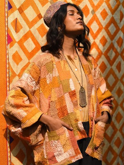 A joyful, sun-kissed moment against a vibrant, patterned backdrop. This shot is a celebration of color, texture, and the warmth of artisanal craftsmanship.