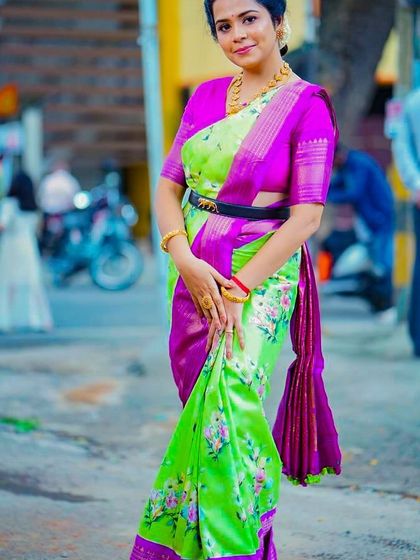 The contrasting purple blouse and neon green saree create a bold, contemporary look that is sure to turn heads.