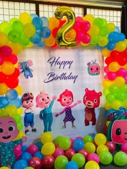 A vibrant and fun Cocomelon theme party for a 2nd birthday. This setup includes a colorful balloon arch, a custom backdrop with all the favorite characters, and a floor full of balloons for the kids to play in.