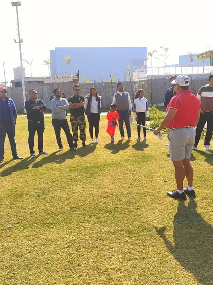 Participants of all ages listen as pro golfer Simi Mehra conducts a masterclass, demonstrating the inclusive and educational environment we foster.