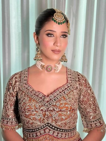 A new era bridal look with a focus on smokey eyes and a heavy, traditional blouse.