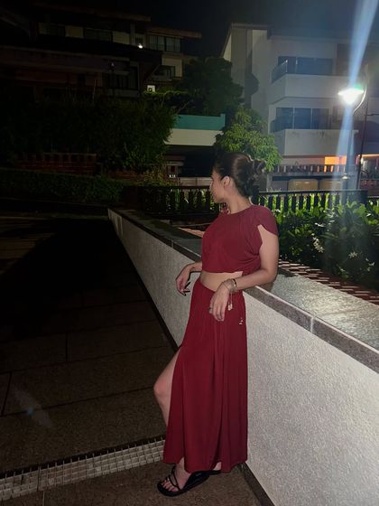 A candid shot in my red co-ord set. The messy bun hairstyle keeps it casual and perfect for a warm evening.