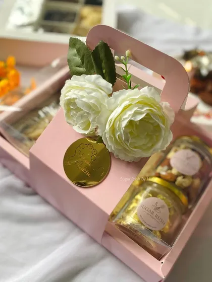 The 'Pyaar Bhaara' Rakhi hamper, because it's truly filled with love. This box includes a tea cake, brownies, cookies, and jars of roasted nuts and chocolates.