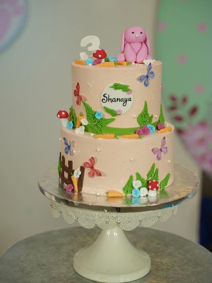Another shot of the garden bunny cake on its stand, ready for the celebration.