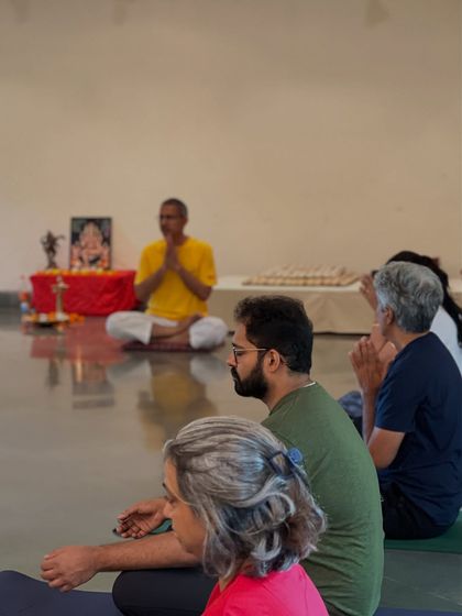 A satsang in progress, with participants seated in meditation. These spiritual gatherings are a time for quiet reflection and connecting with the group's collective energy.