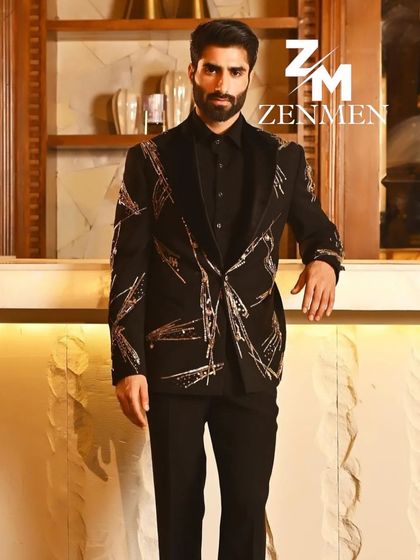 A model wearing a black tuxedo with abstract gold sequin embroidery. This look is perfect for a glamorous evening event, blending artistry with sharp tailoring.