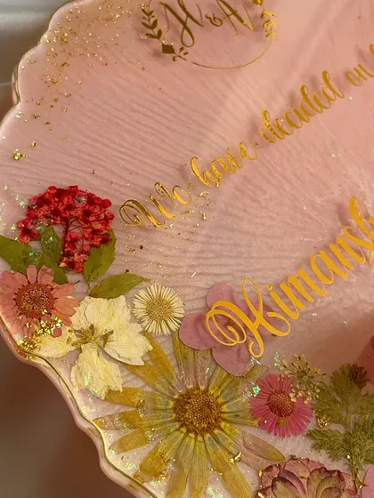 The details matter. Here you can see the custom monogram and quote, "We have decided on forever," surrounded by carefully placed real flowers.