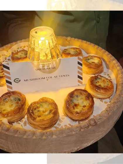 Our creamy Mushroom Vol au Vents, served warm on a platter with a candle for a cozy, intimate feel. These flaky, savory pastries were a perfect addition to a festive Diwali dinner.