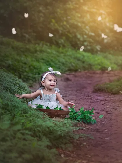 A little angel in a forest of dreams. The warm sunlight and floating butterflies create a whimsical and heartwarming scene.