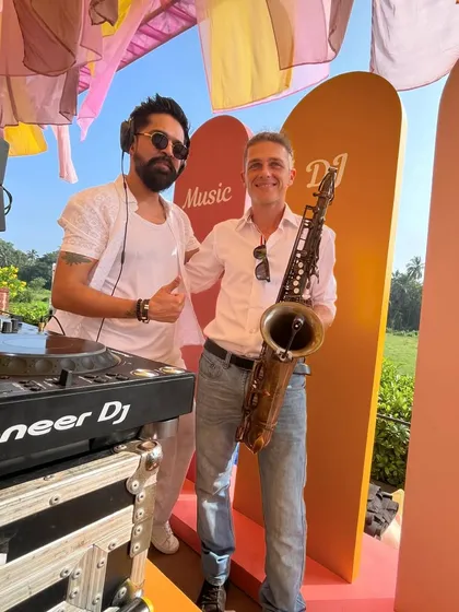 Collaborating with a live saxophonist during a Goa wedding brunch. I love fusing my DJ sets with live instruments to create a unique, sophisticated sound for special occasions.