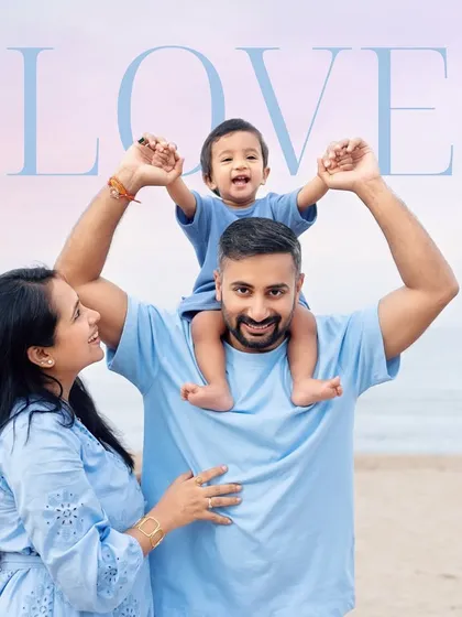 A classic "on the shoulders" pose at the beach. The love and happiness in this family portrait are as vast as the ocean behind them.