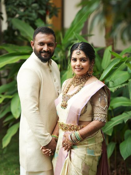 A close-up of the happy family. The intricate embroidery on the mother's blouse is subtly echoed in the father's and baby's outfits.