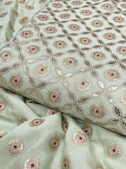 This off-white Chinon fabric offers a classic and versatile base for the intricate silver Gotta Patti embroidery. It's a premium material suitable for elegant kurtas or anarkalis.