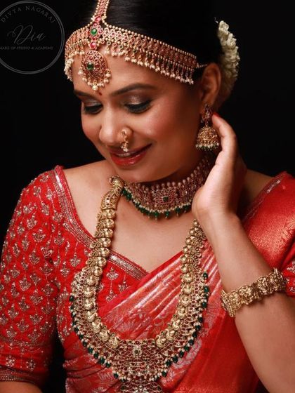 A smiling portrait from a portfolio shoot, this look is all about bridal joy. The makeup is flawless, with defined eyes and a warm smile, perfectly capturing the essence of a happy South Indian bride.