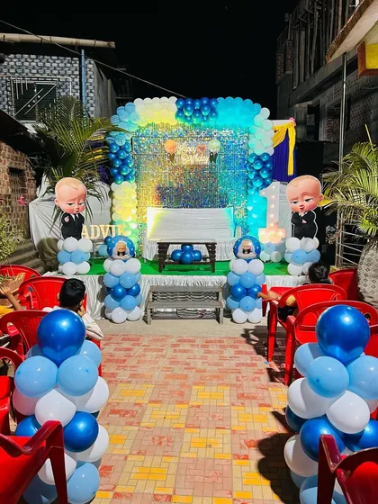 Here is a complete Boss Baby themed birthday stage I designed. The setup includes a shimmering sequin backdrop, character cutouts, and a blue and white balloon arch, perfect for a stylish first birthday party.