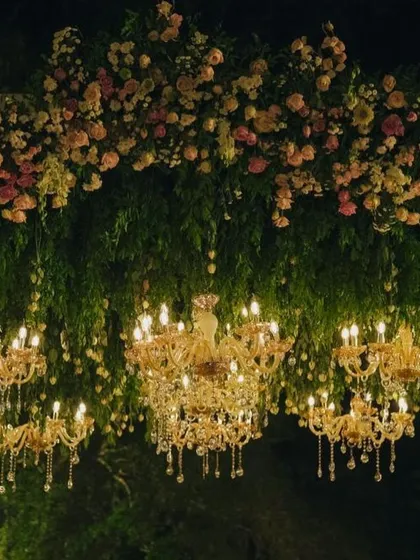 Transforming a daytime celebration into a magical evening is one of my favorite challenges. Here, we suspended dozens of crystal chandeliers from a canopy of lush greenery and pastel roses, creating an ethereal glow for a romantic cocktail party.
