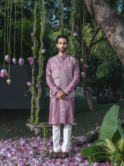 A modern, layered kurta set in a unique mauve shade. The ensemble features an embroidered, overlapping jacket-style panel, offering a contemporary twist on traditional wear.