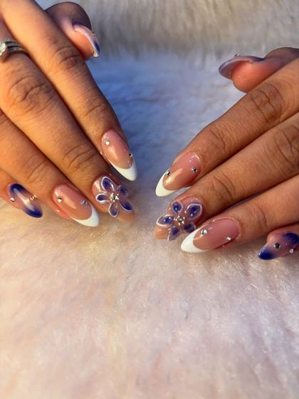 A full view of this beautiful vacation set, showing the combination of a classic French manicure with 3D floral accents. It's a balanced look that's both elegant and playful.