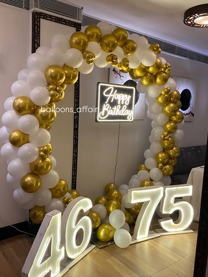 The combination of a circular balloon arch and large light-up numbers creates a professional and high-impact photo zone for any party.