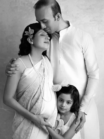 A timeless black and white version of a family portrait. It strips away the color to focus purely on the emotion and the beautiful connection between them.