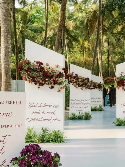 I believe in making every detail personal. For this aisle, we created modern white panels inscribed with the couple's favorite quotes, telling their story as they walk towards their future.